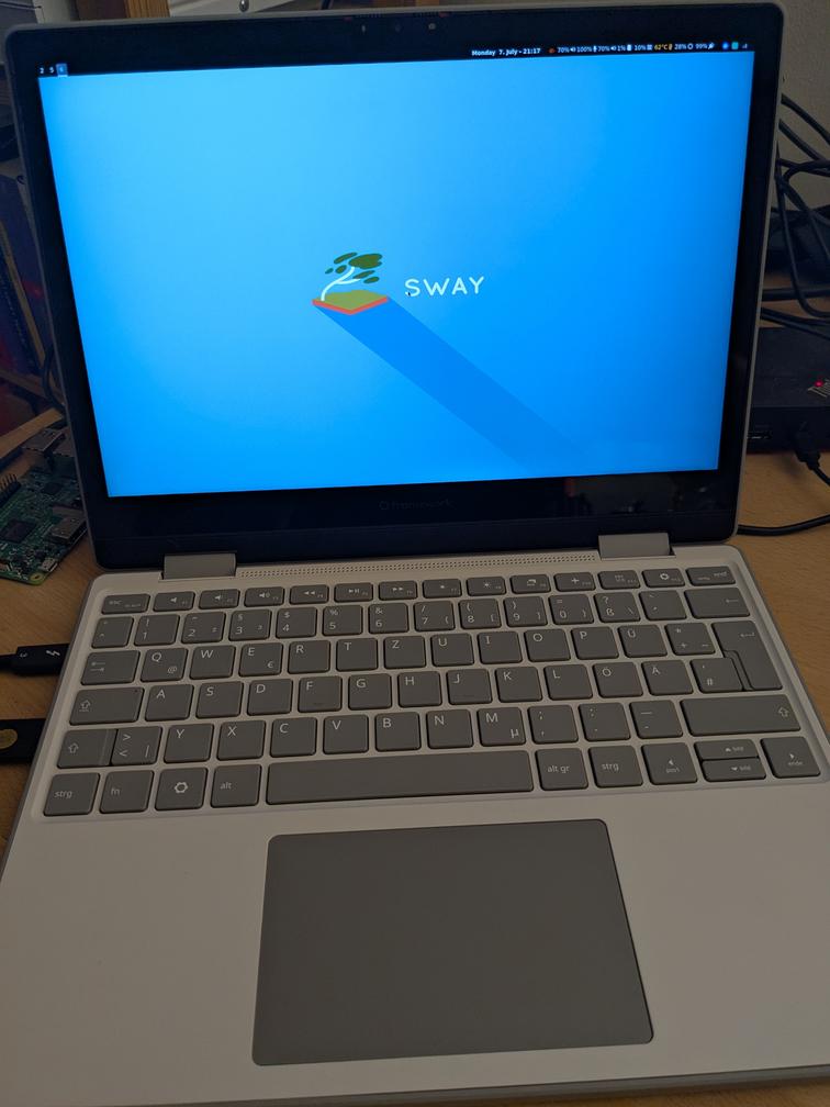 Image of the a Framework 12 laptop, showing the default Sway background image